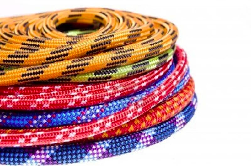 various brightly colored climbing ropes stacked