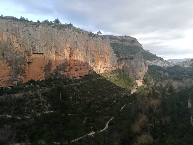 town of chulilla with rock climbing walls at sunset