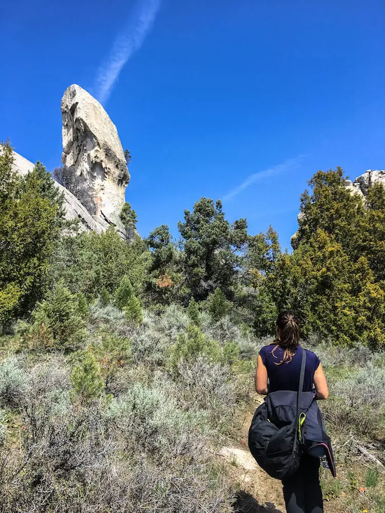 woman looking at lost arrow spire in the city of rocks national park