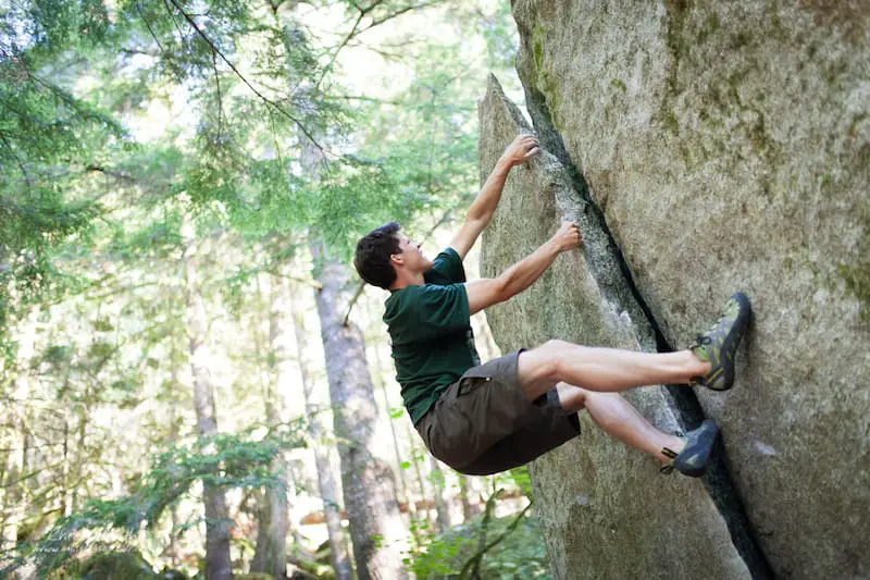 climber bouldering a v1 layback crack