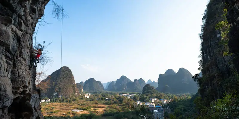 Woman rock climbing in Yangshuo China