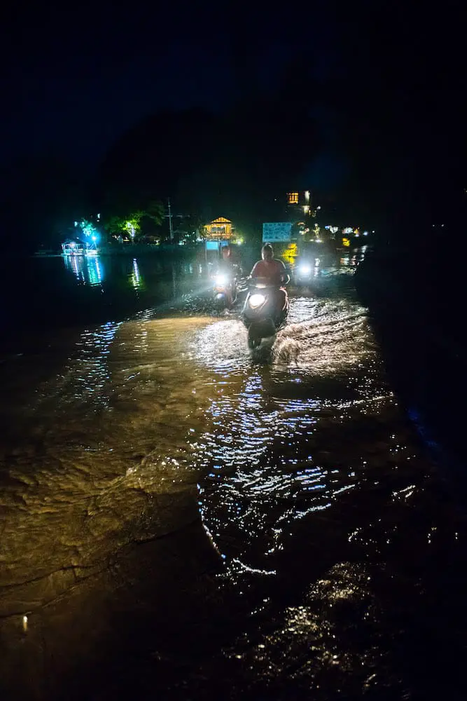scooters driving through flooded streets of Yangshuo china