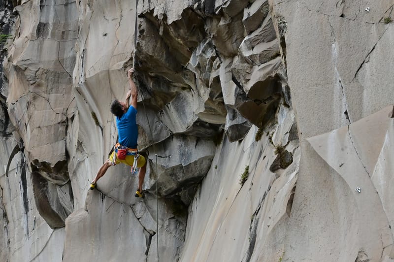 Climber clipping on el perro meilvin route in chile