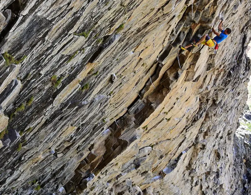Rock climber mid route on Anarquia Creativa in the Valle de los Condores