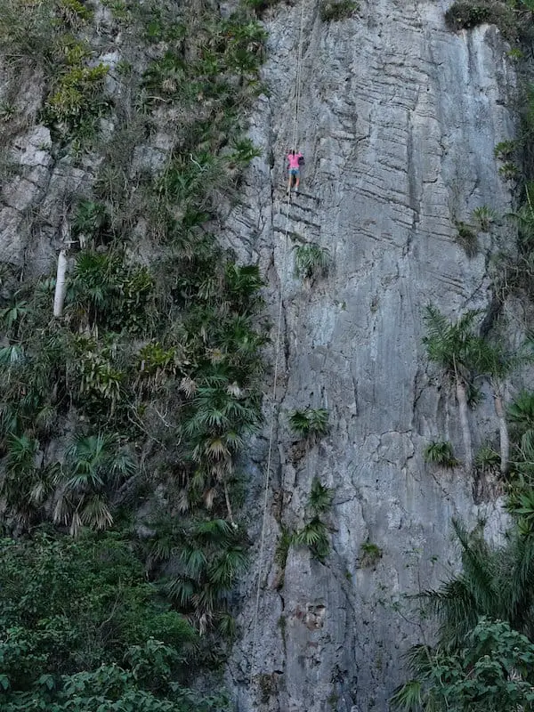 woman in pink climbing in cuba