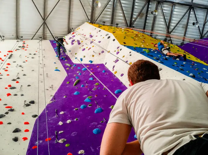 two climbers top roping in climbing gym