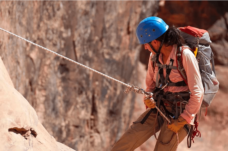 women rappling with blue helmet