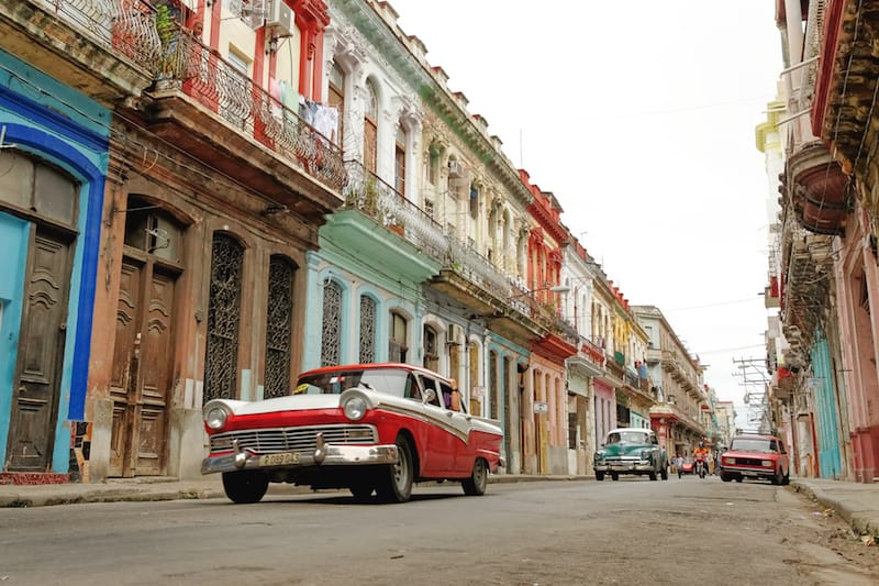 classic red car parked in the streets of havana