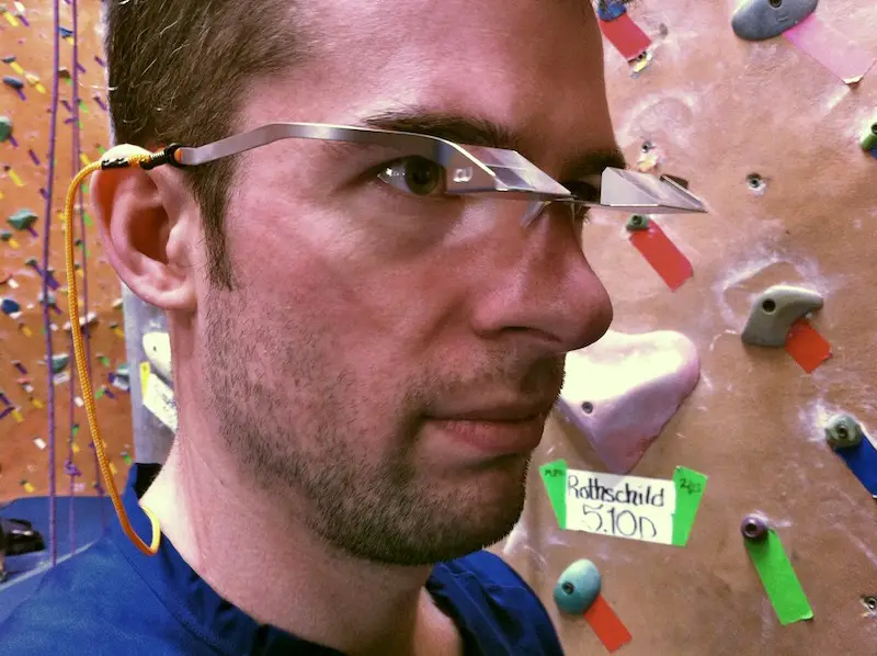 man in climbing gym with belay glasses on