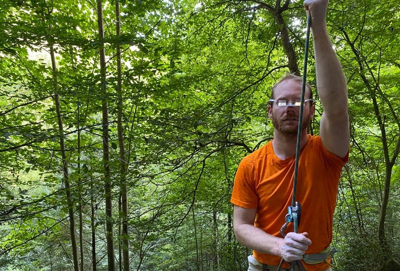 man belaying wearing belay glasses