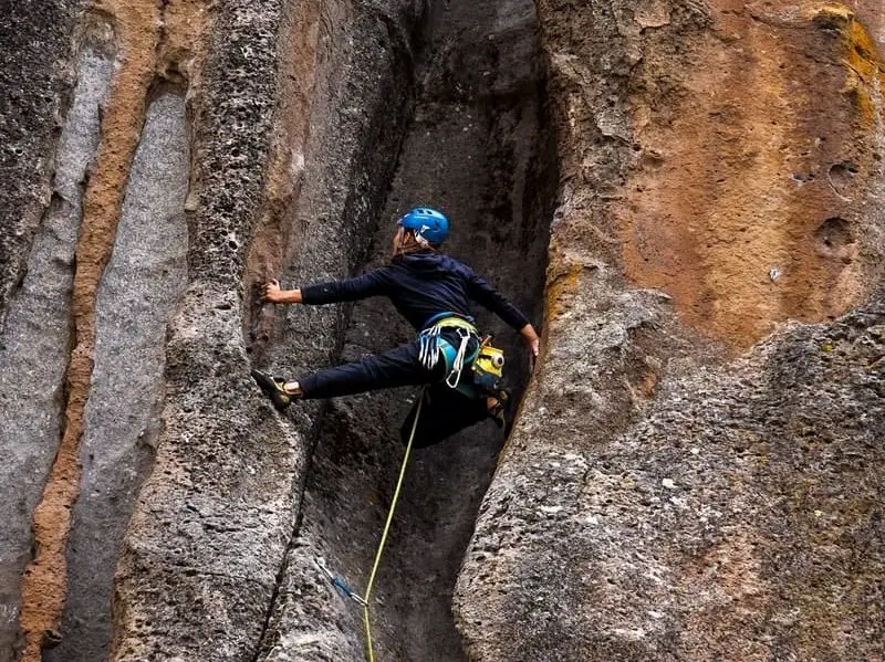 woman rock climbing with rope