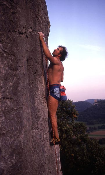 man rock climbing wearing shorts