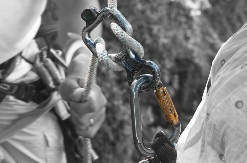 man using a figure 8 belay device