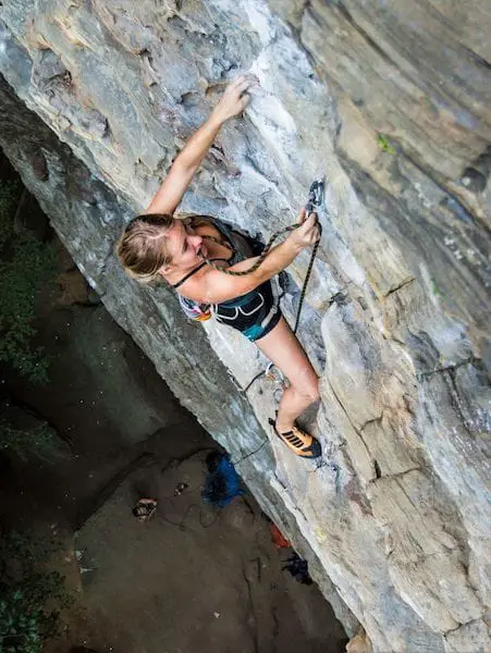 Woman climbing on rocks