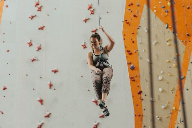 Woman is climbing in gym