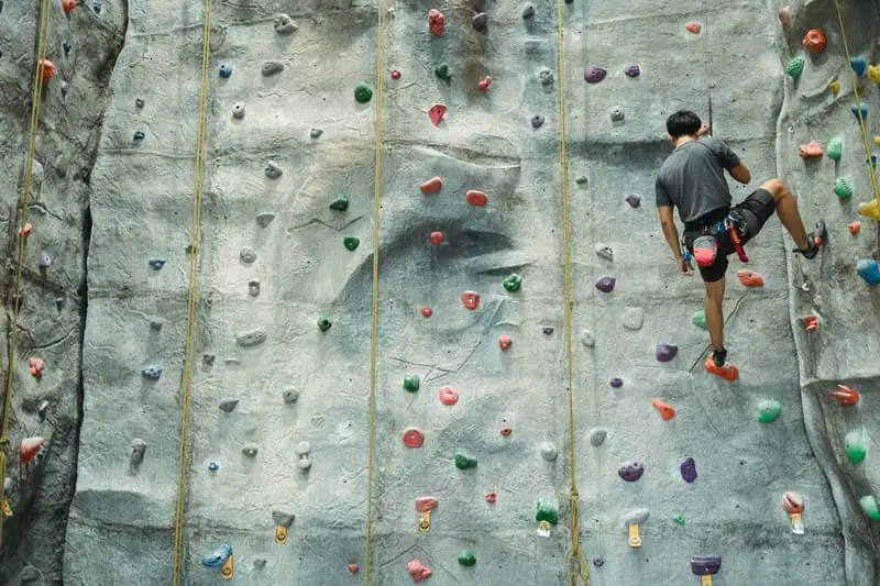 man top rope climbing in gym