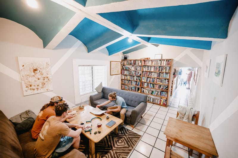 Three rock climbers drinking coffee and reading books on a rest day