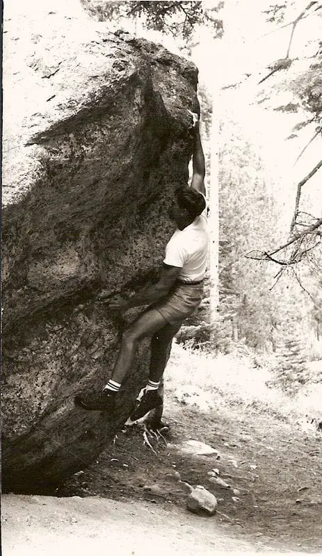 Old photo of man practicing bouldering