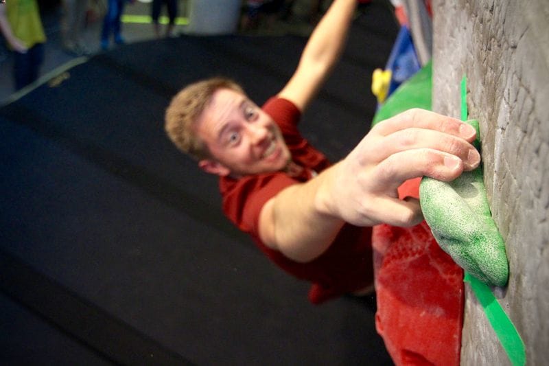 Person practicing bouldering in gym