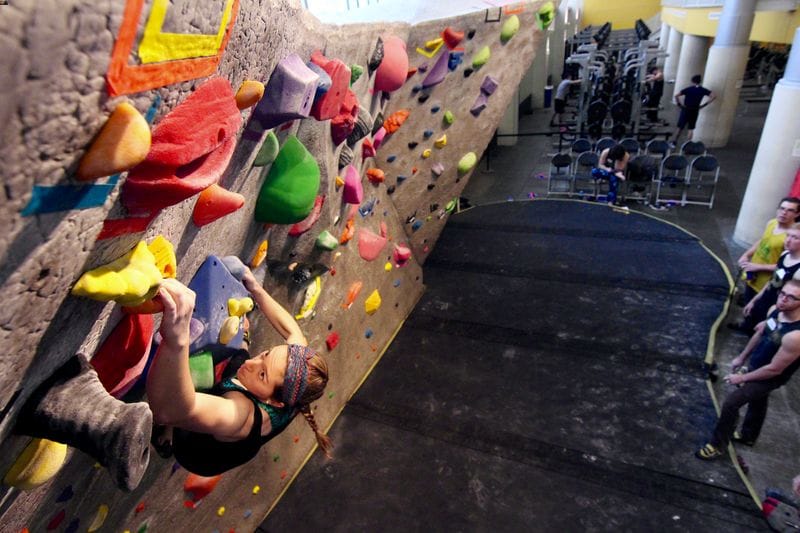 Person practicing bouldering in gym