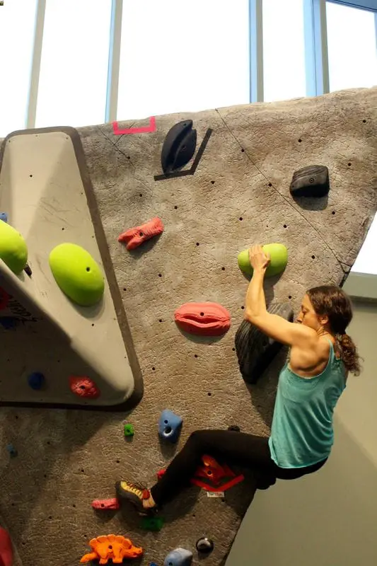Person practicing bouldering in gym