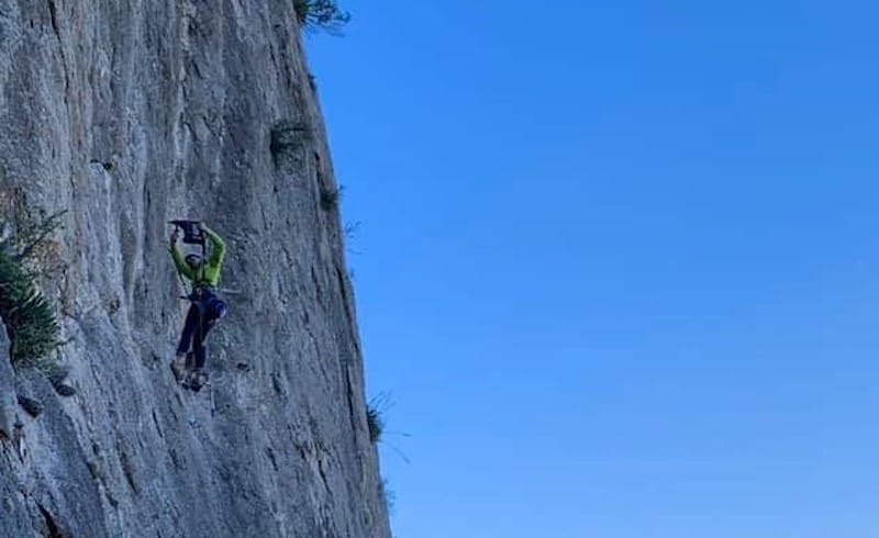 Person bolting new climbing line