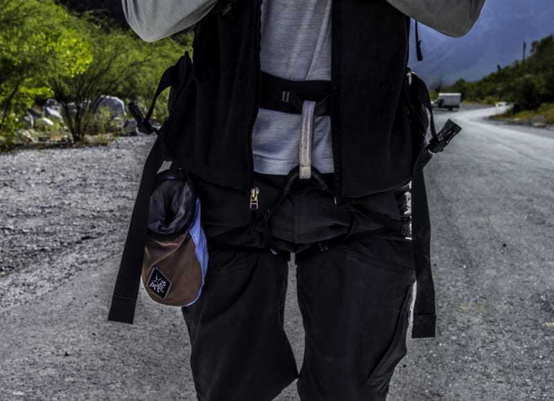 Sport climbing harness seen with chalk bag on gravel road