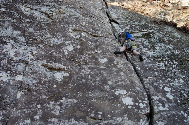 Person climbing with mountain view 