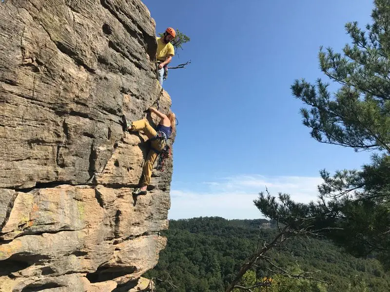 Woman climbing rock 