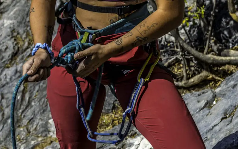 women tying into her harness 