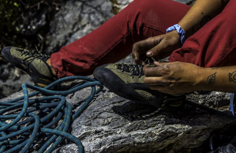 rock climber putting on shoes