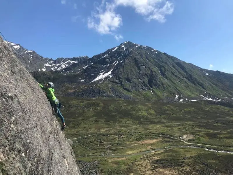 Person climbing with mountain view