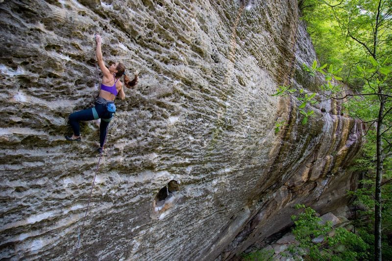 Woman climbing rock 