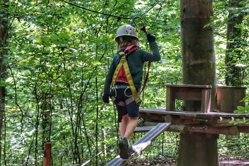Girl climbing in full body harness