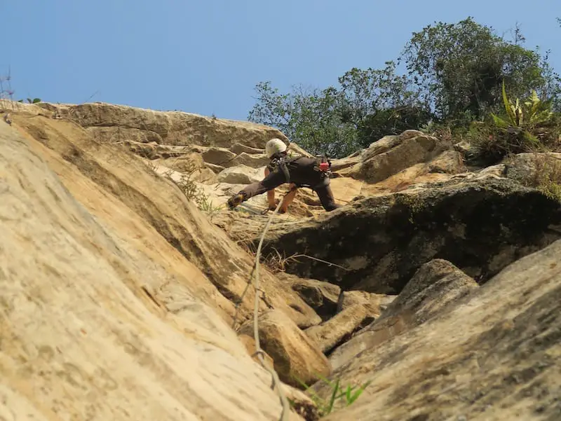  person rock climbing seen from below