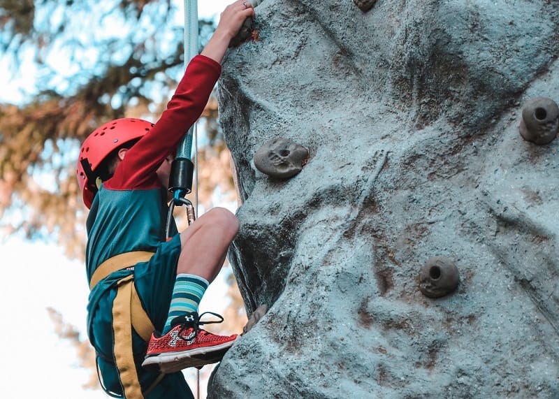 boy climbing rock