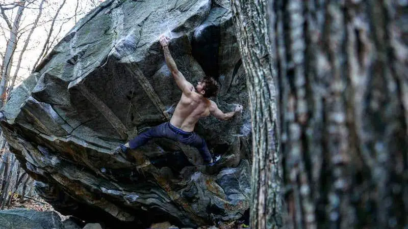 man climbing arms outstretched
