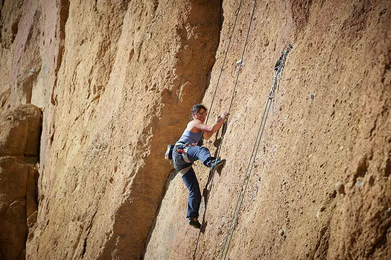 woman climbing rock
