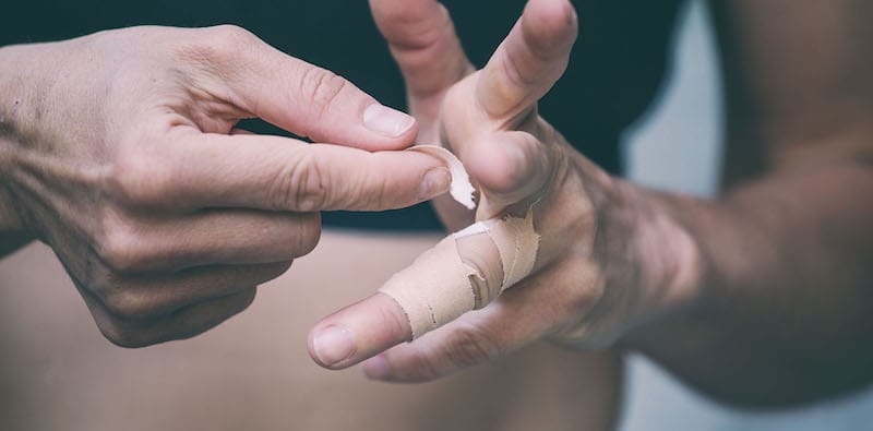 woman putting tape on hands