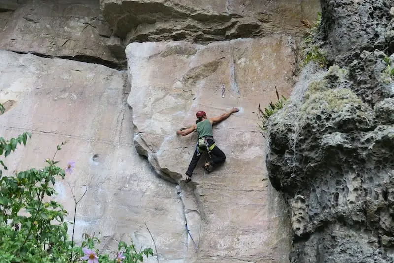 man climbing rock in suesca colombia 